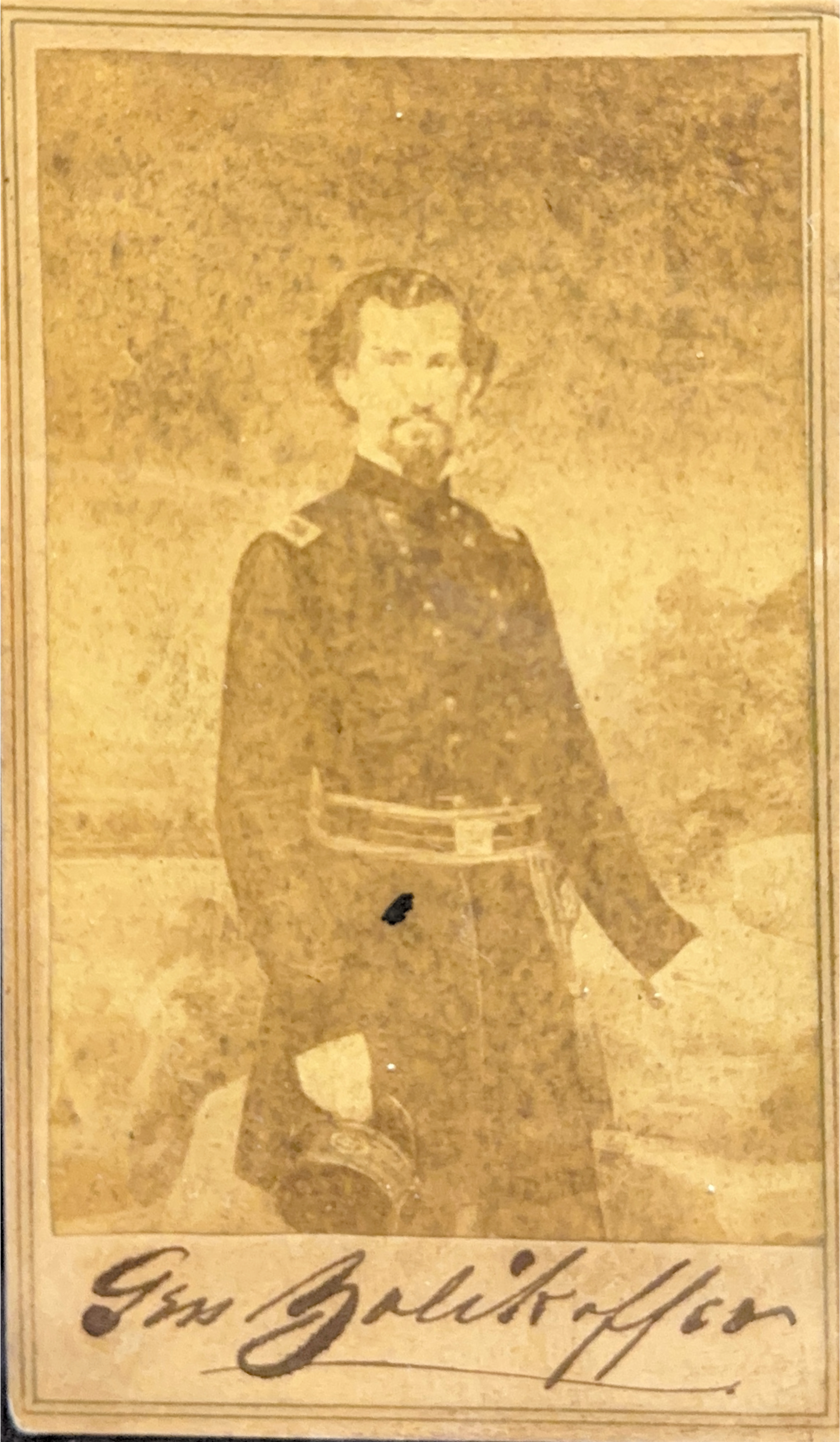 Portrait of  Felix Kirk Zollicoffer standing facing the camera with his left hand resting on a table. His right hand is holding his uniform hat. His name is written at the bottom of the image in cursive.